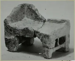 Fragmentary stone object from Marion with an incised pattern of diagonal lines and two rectangular openings.