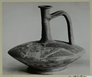 Cypro-Hell. II jug with a tall neck, flaring rim and strap handle, from the Marion tomb finds