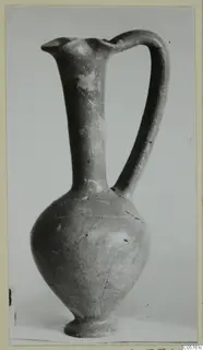 Pottery jug with a tall neck, pinched lip and strap handle, from the Amathus tombs series