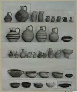 Pottery of Period 4 from Ayia Irini: jugs, juglets, bowls and pots arranged in rows on a board