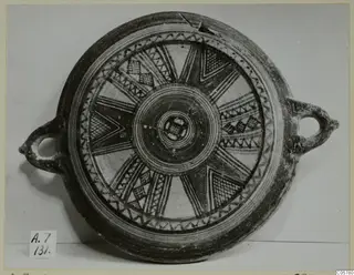 Pottery Bichrome III dish with two loop handles and a radiating painted pattern