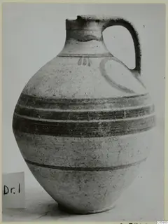 Pottery White Painted VI jug with a single loop handle and dark horizontal bands around the body