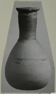 Pottery unguentarium from Amathus with a flaring rim, long narrow neck and rounded body, shown upright