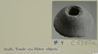 Rounded stone object with a wide circular opening in its top, from Stylli Tomb 17.
