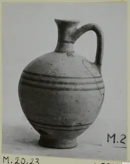 Pottery White Painted VI jug from Marion, with a single handle and dark painted bands