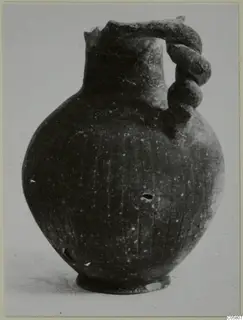 Pottery Black Slip Ware jug with a twisted handle and broken rim, from Amathus