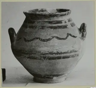 Painted pottery jar with two handles, dark horizontal bands and a wavy line around the shoulder