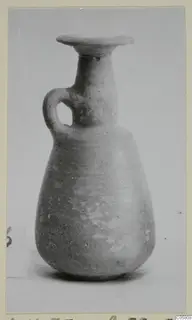 Pottery Red Slip jug with a flared rim and a single loop handle, photographed upright