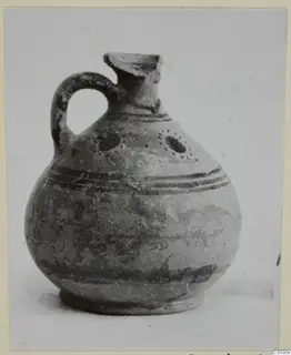 Pottery juglet, White Painted VII, with a loop handle, dark painted bands and dotted circles on the body