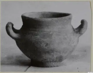 Amphoriskos of Pottery Stroke Polished Ware from Marion, with two handles, photographed on a pale surface.