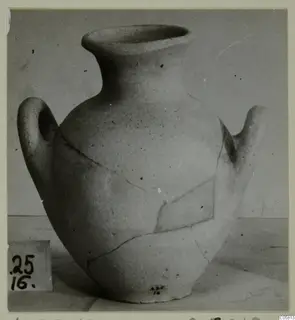Pottery vessel with a wide mouth, two handles and a cracked body, photographed from the Amathus tombs series.
