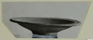 Pottery Red Slip bowl with a wide, flaring rim, photographed from the side