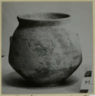 Pottery jar of Bichrome-Red ware with a wide rim and small handles, photographed on a plain surface