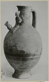 Pottery Black-on-Red jug from Marion, with a tubular spout, strap handle and ring foot