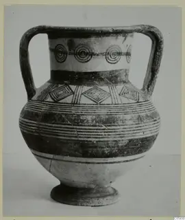 Two-handled painted pottery vessel on a low foot, with a band of concentric circles and diamond motifs