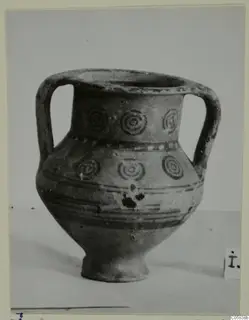 Pottery Bichrome V two-handled jar with dark concentric circle motifs and horizontal painted bands