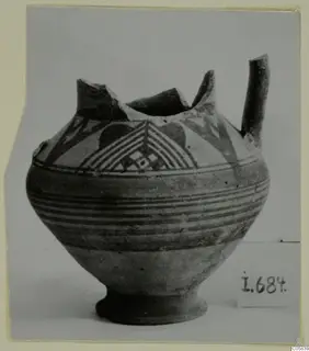 Pottery Bichrome IV vessel from Idalion with painted chevrons, bands and a side spout, rim broken