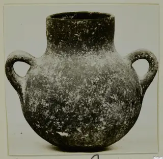 Coarse ware pot with a wide neck and two loop handles, photographed against a plain background.