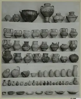 Pottery vessels from a deposit at Idalion, arranged in rows: bowls, two-handled jars, jugs and small juglets.
