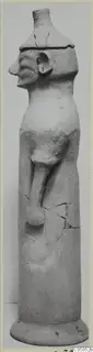 Terracotta figure with a cylindrical body, profile head and one bent arm, standing on a round base
