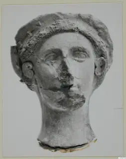 Head of a sculpture from Mersinaki with hair in raised bands, cracked across the face and broken at the neck.