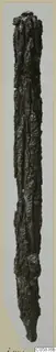Long corroded iron weapon, narrow and pointed at the lower end, photographed upright on a pale card