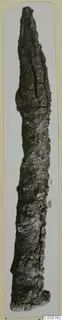 Long, pointed iron weapon, heavily corroded, photographed upright against a pale card