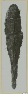 Corroded iron weapon from Idalion: a long, tapering blade shown on a pale card mount.