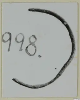 Fragment of a bronze ring from Idalion, photographed flat beside a handwritten number label