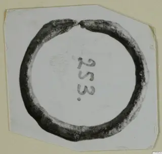 Bronze finger ring with a small gap, from Idalion, photographed on white card with a number label