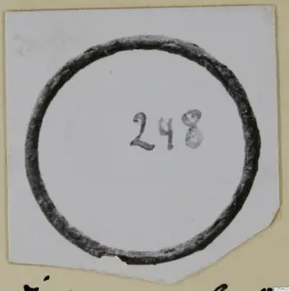 Bronze ring on a small white card, with a handwritten number label