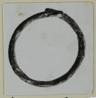 Bronze finger ring photographed against a plain background
