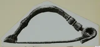 Bronze personal adornment from Idalion with an arched bow, moulded swellings and a coiled loop at one end