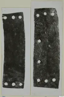Two flat dark metal strips with rows of rivet holes, bronze mountings and fragments from Idalion
