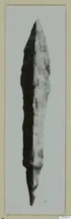 Pointed, elongated metal blade, probably a weapon, from Idalion, shown on a mounted photograph card.