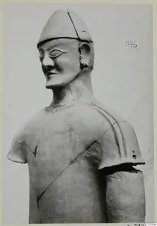 Terracotta statue of a figure in a conical cap, head and upper torso, one arm, from the Terracotta Proto-Cypriote I series