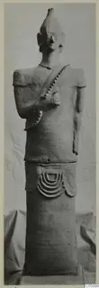 Terracotta Proto-Cypriote II, a standing figure with a conical headdress and a cylindrical base, from Ayia Irini