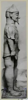 Terracotta Proto-Cypriote I, a standing bearded figure in profile facing right, on a base.