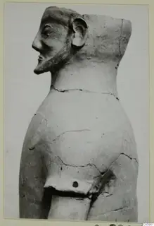 Terracotta figure in side profile with a long nose, pointed beard and flat-topped head