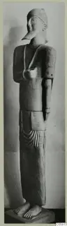 Terracotta Neo-Cypriote statue of a standing figure with a long pointed nose and close-fitting cap