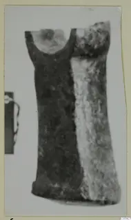 Bronze tool from Idalion with a rounded socket at its upper end, shown in a photograph on a card mount