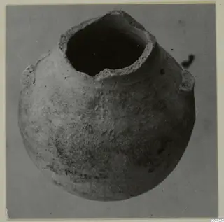 Pottery Bichrome V vessel from Idalion, photographed mouth-up, with a round body and two small projections on the shoulder