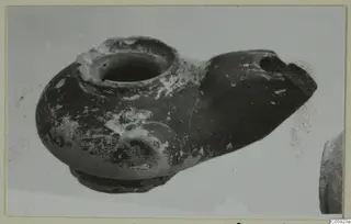 Terracotta lamp from Idalion with a filling hole and a pointed spout, seen from the side