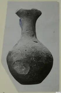Grey polished pottery bottle with a flared rim and a round body, photographed against a plain background.