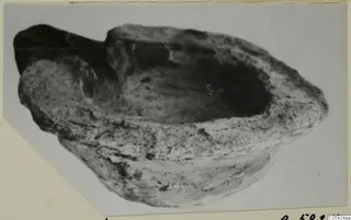 Terracotta lamp from Idalion, a shallow open bowl with a raised lip at one end.