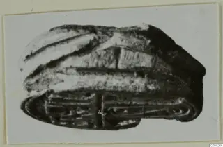 Stone scarab from Idalion, with a ridged domed back and incised lines on its flat base
