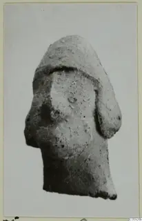 Terracotta figurine fragment from Idalion, broken at the base, with a rounded upper part