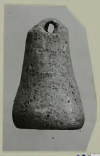 Pierced porous stone object, tapering toward the base, with a suspension hole near the top