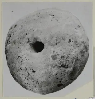 Large disc-shaped find with a central hole and pitted surface, from Idalion