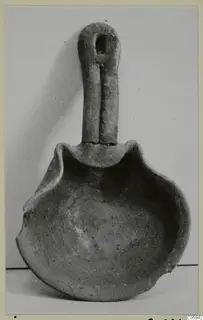 Terracotta lamp with a tall loop handle and a shallow open bowl with a pinched rim.